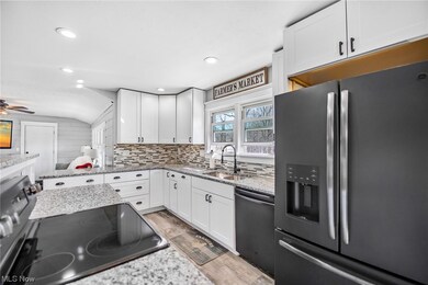 Kitchen with dishwasher, stove, ceiling fan, tasteful backsplash, and stainless steel fridge with ice dispenser
