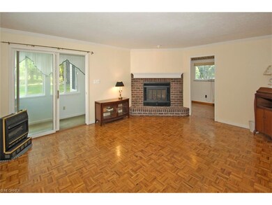 Open and Bright this Oversized family Room with Wood Burning Fireplace is open to the Sunroom and Office.