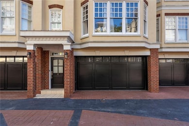Property entrance featuring brick siding and a garage