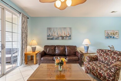 Tiled living room with visible vents and a ceiling