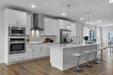 Note the Custom cabinets, quartz countertop & stai
