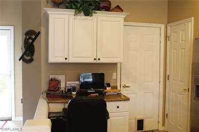 A built in granite desk and cabinets in the kitche