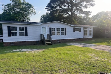 Manufactured / mobile home featuring entry steps, crawl space, and a front lawn