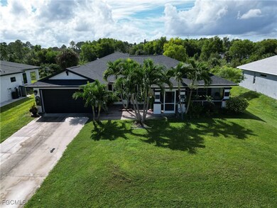 Ranch-style home featuring concrete driveway, a front yard, an attached garage, and roof with shingles