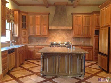 Kitchen with island, granite counters and cypress 