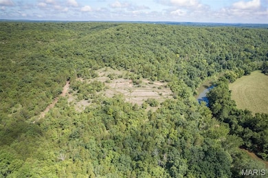 View of property location featuring a heavily wooded area