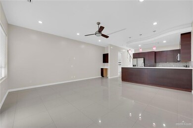 Unfurnished living room featuring a ceiling fan, light tile patterned floors, and recessed lighting