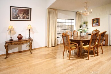 The formal dining room with its elegant drop down chandelier, wet bar and striking hardwood floors fittingly adjoins the kitchen and is perfect for any occasion.