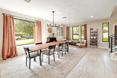 Dining area with a chandelier, recessed lighting,