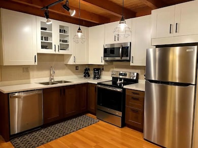 Kitchen with light wood-type flooring, a sink, sta