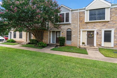 View of front of home with a front yard and brick