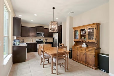 Dining room with light tile patterned floors, rec