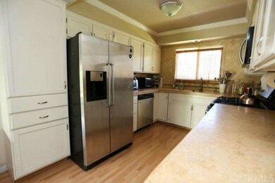 Remodeled kitchen with crown molding, white cabine