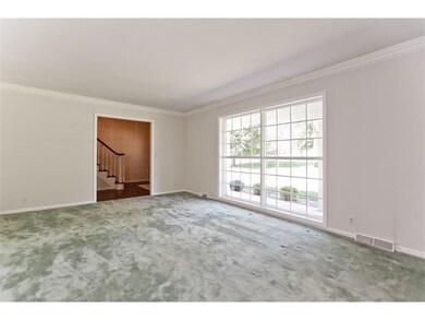 Bright 18 X 13 formal living room with crown moldi
