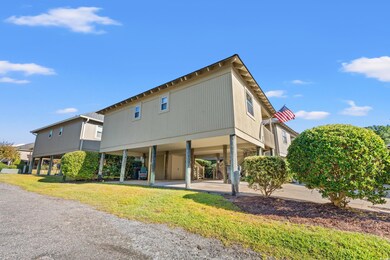 Back of property with a lawn and a carport