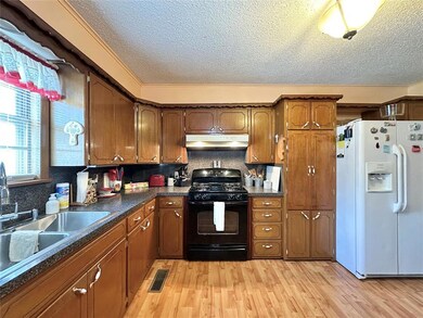 Kitchen featuring black range with gas cooktop, fu