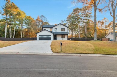 View of front of property with a chimney, driveway, and covered porch