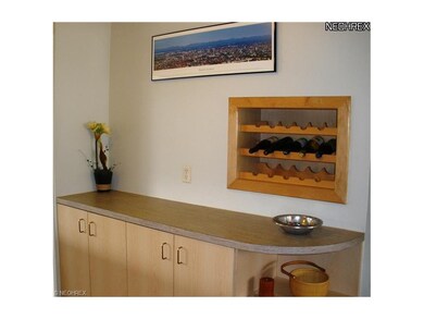 The kitchen has ample storage and a custom wine rack.
