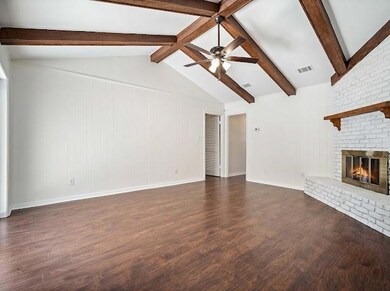 Unfurnished living room with ceiling fan, a firepl