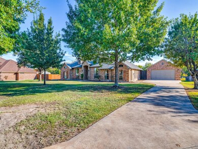 Ranch-style house featuring a large treed front ya