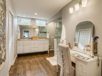 enter the master bath with dressing table on right. Note the hardwood floors carried through from the owner's suite.