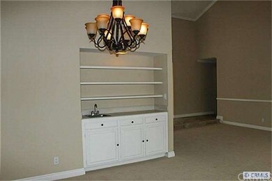 The living room has a functional wet bar with beau