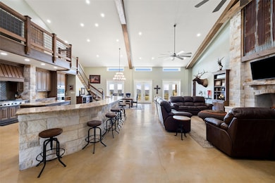 Living room featuring high vaulted ceiling, a cei