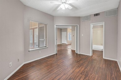 Spare room with dark wood-type flooring, ceiling f