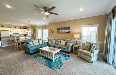 Living room with light carpet, ceiling fan, and cr