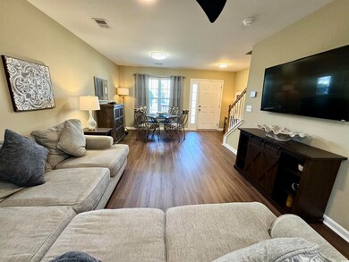 Living room with dark wood-type flooring