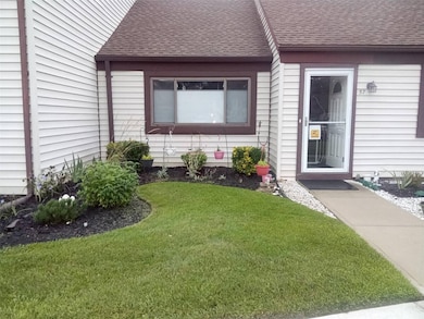 View of exterior entry featuring a yard
