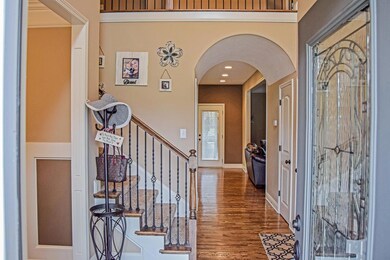 Welcoming Entry Foyer with Hardwood Flooring, Crown, and Barrel Ceiling
