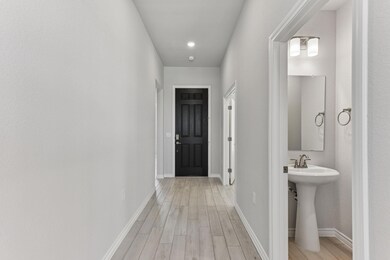 Hall featuring light wood finished floors and recessed lighting