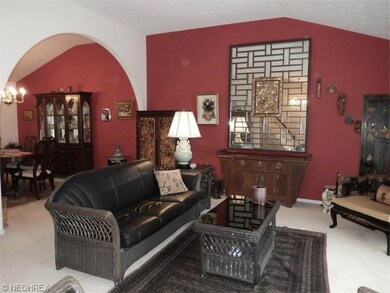 Additional view of vaulted living room leading to 