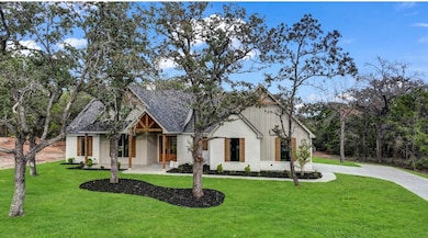 Modern farmhouse with a front lawn and driveway