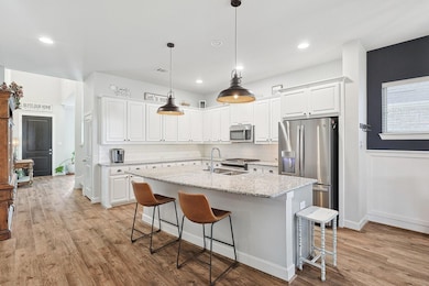 Kitchen featuring stainless steel appliances, whit