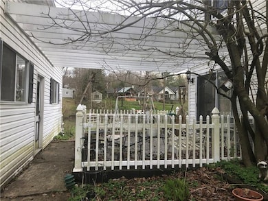 The brick patio with the vinyl fencing and pergola