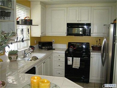 Tile counters, recessed lighting and custom glass 