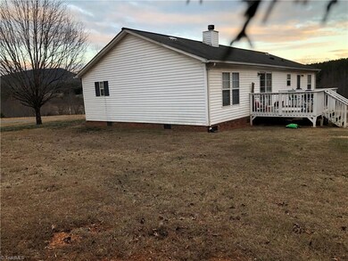 side view shows the mountain view and the deck on the back of the home.