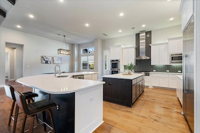 Kitchen with a spacious island, a sink, stainless