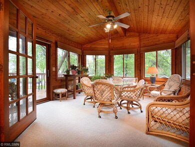 Three seasons porch overlooks the lush backyard.