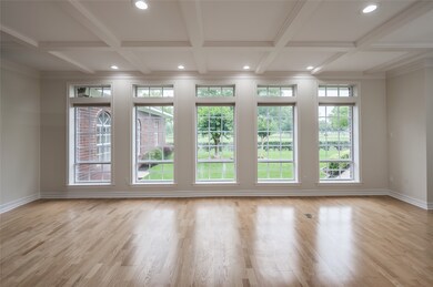 The living room features an elegant coffered ceili