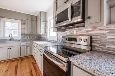 Renovated kitchen with new stainless steel appliances, granite counter tops, new cabinetry and refinished hardwood floors.