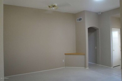 Another view of living room with a shelf