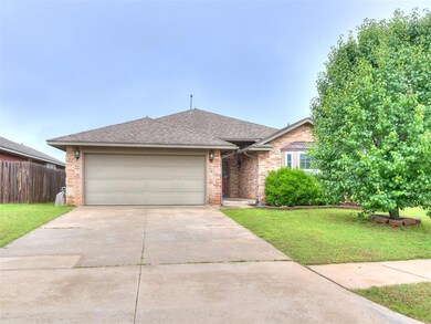 Ranch-style home featuring driveway, roof with shingles, a garage, and brick siding