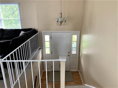 Entry way with overhead light fixture and laminate
