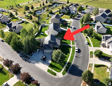 Aerial view of property and surrounding area featuring nearby suburban area