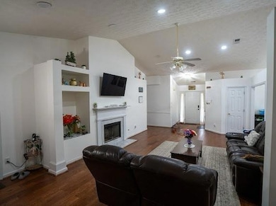 Living area with wood finished floors, a ceiling f