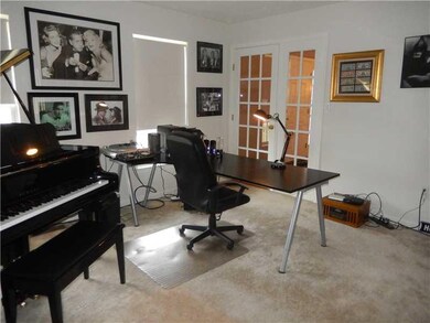 Den. 1st floor den or Living room with glass doors