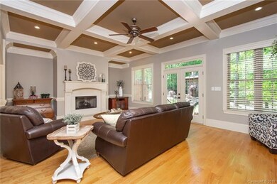 Spacious great room with coffered ceiling, gas fir
